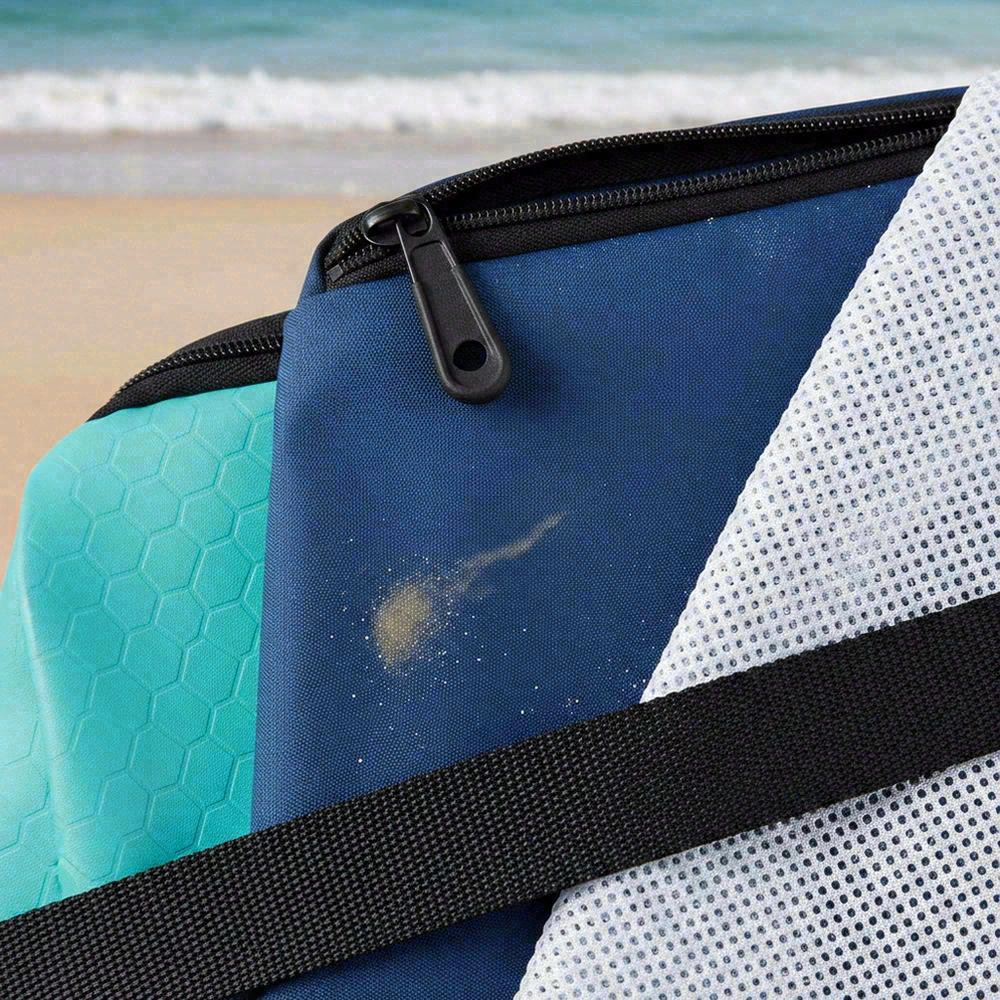 Beach backpack material options close-up showing coated fabric, mesh panel, zipper, and webbing