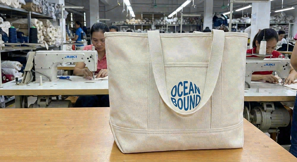 Canvas beach bag showing durability features—reinforced stitching, sturdy handles, branded logo print
