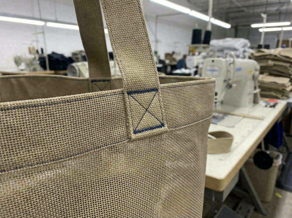 Reinforced handle stitching on mesh beach bag