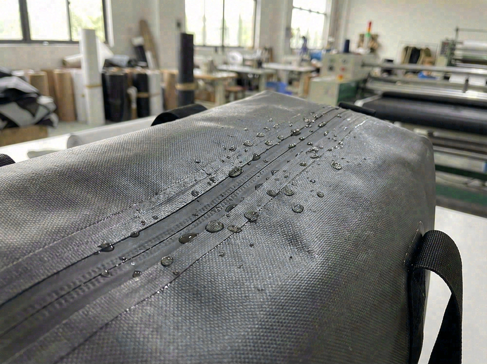 Waterproof beach tote zipper detail showing seam tape and water droplets